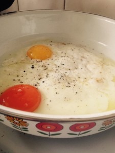 Cook eggs without breaking yolks until the bottom begins to set.  Add scant teaspoon water and put on lid.